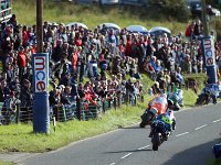PMAKER120817Ulster_Grand_Prix070 PACEMAKER, BELFAST, 12/8/2017: Dan Kneen (Tyco BMW) gets on to the dirt at Quarry as he tries to stay ahead of Dean Harrison (Silicone Kawasaki), Conor Cummins...